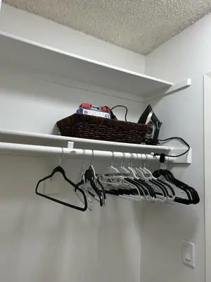 a shelf with a basket and hangers in a closet at Hollywood Blvd Studio FREE DESIGNATED PARKING & WIFI in Los Angeles