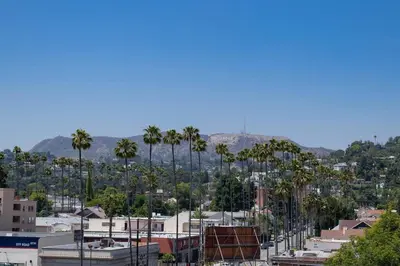 a view of a city with palm trees and buildings at Hollywood 1Bed Apt w Rooftop pool & Panoramic View in Los Angeles