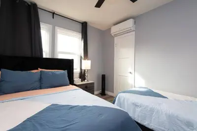 a bedroom with two beds and a window at Lovely 3bedroom condo with free parking on premise in Los Angeles