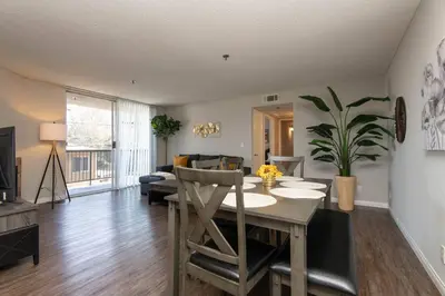 a living room with a dining room table and a couch at Hollywood 2Bed Apt w Rooftop pool & Panoramic View in Los Angeles