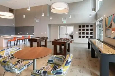 a dining room with ping pong tables and chairs at Comfy Cozy Apt with pool & hot tub in downtown LA' in Los Angeles