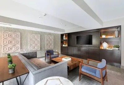 a living room with a couch and a tv at Comfy Cozy Apt with pool & hot tub in downtown LA' in Los Angeles