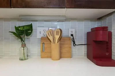 a kitchen counter with wooden cutting boards and a red mixer at Comfy Cozy Apt with pool & hot tub in downtown LA' in Los Angeles