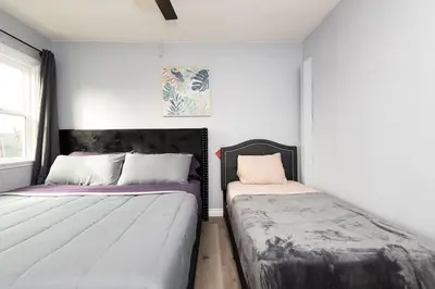 two beds sitting next to each other in a bedroom at Lovely 3bedroom condo with free parking on premise in Los Angeles