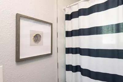 a picture frame on a wall next to a shower curtain at Lovely 2bedroom condo with free parking on premise in Los Angeles