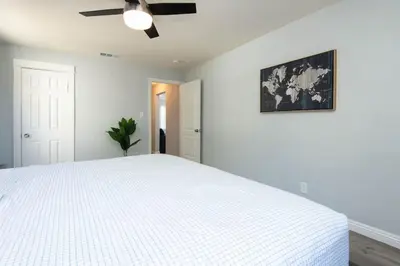 a white bedroom with a bed and a ceiling fan at Lovely 2bedroom condo with free parking on premise in Los Angeles