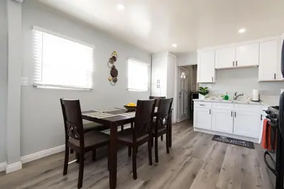 a kitchen and dining room with a table and chairs at Lovely 2bedroom condo with free parking on premise in Los Angeles