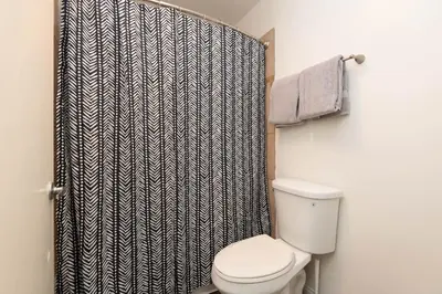 a bathroom with a toilet and a shower curtain at Hollywood 2Bed Apt w Rooftop pool & Panoramic View in Los Angeles