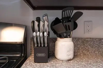 a container of kitchen utensils sitting on a counter at Hollywood 2Bed Apt w Rooftop pool & Panoramic View in Los Angeles