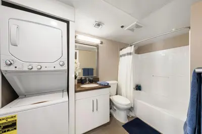 a white bathroom with a toilet and a sink at Carnelian Calm-Pool BBQ Rooftop Walk to the Beach in Los Angeles