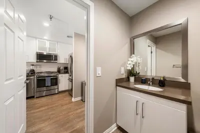 a kitchen with a sink and a mirror at Carnelian Calm-Pool BBQ Rooftop Walk to the Beach in Los Angeles