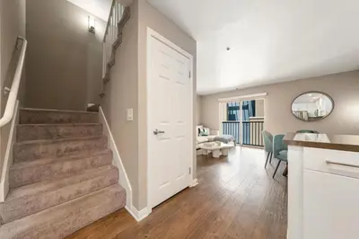 a hallway with a staircase and a living room at Carnelian Calm-Pool BBQ Rooftop Walk to the Beach in Los Angeles