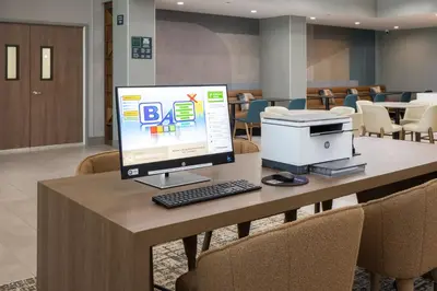 a desk with a computer on top of it at Holiday Inn & Suites Monterey Park – Los Angeles by IHG in Monterey Park