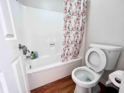 a bathroom with a toilet and a shower curtain at Ocean 2 min, free pool & parking in Los Angeles