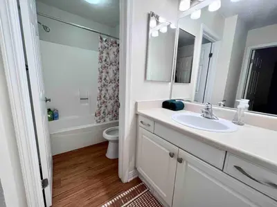 a bathroom with a sink and a toilet and a mirror at Ocean 2 min, free pool & parking in Los Angeles