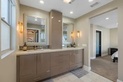 a bathroom with two sinks and a large mirror at Voted Airbnb Most Loved Home 2024 Duffy Boat in Huntington Beach