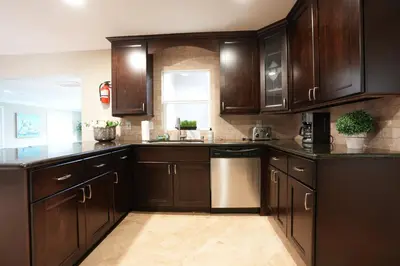 a kitchen with dark brown cabinets and a window at Destination #06 in Anaheim