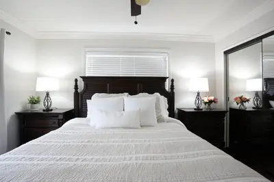 a bedroom with a large white bed with two night stands at Destination #02 in Anaheim