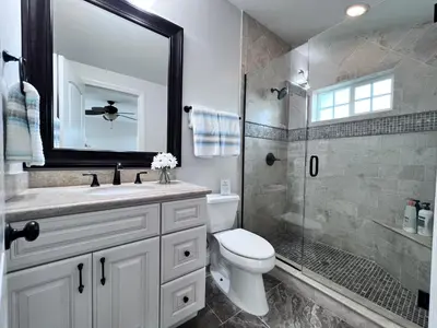 a bathroom with a toilet and a sink and a shower at Destination #02 in Anaheim