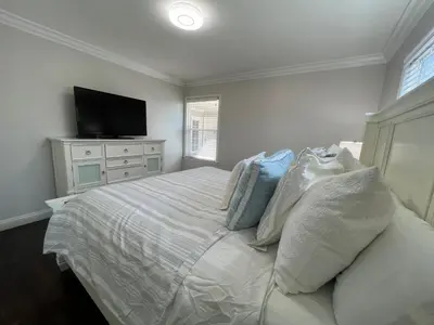 a bedroom with a bed with pillows and a television at Destination #04 in Anaheim