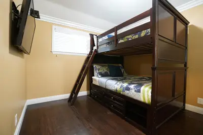 a bedroom with two bunk beds and a television at Destination #04 in Anaheim