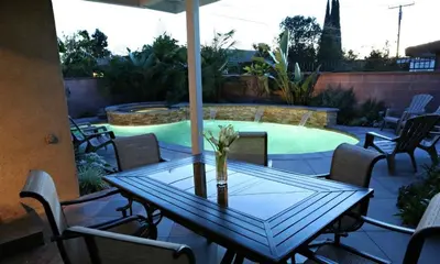a table with a vase of flowers on a patio at Destination #04 in Anaheim