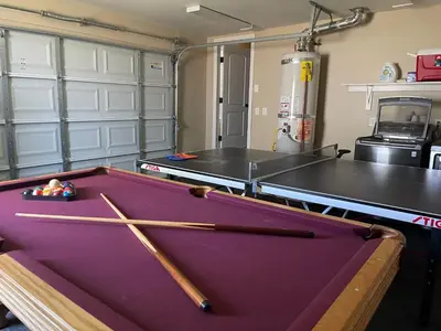 a room with a pool table with two bats at Destination #04 in Anaheim