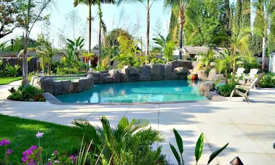 a swimming pool with rocks in a yard at Destination #03 in Fullerton