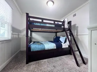 a bedroom with a bunk bed with a ladder at Destination #03 in Fullerton