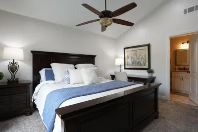 a bedroom with a large bed with a ceiling fan at Destination #07 in Anaheim