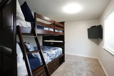 a bedroom with two bunk beds and a television at Destination #07 in Anaheim