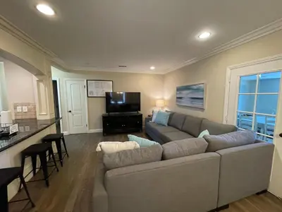 a living room with a couch and a flat screen tv at Destination #10 in Anaheim