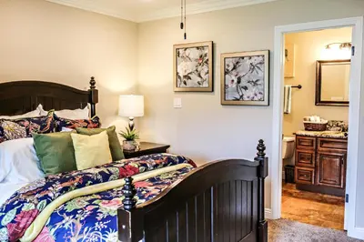 a bedroom with a large bed and a bathroom at Destination #10 in Anaheim