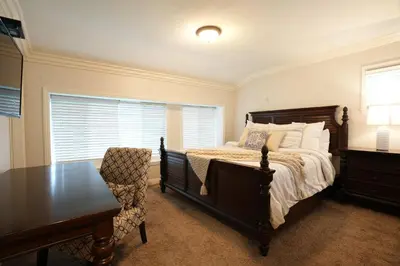 a bedroom with a bed and a table and a chair at Destination #08 in Anaheim