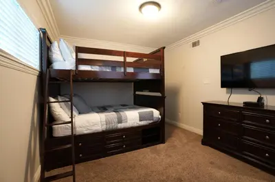 a bedroom with bunk beds and a flat screen tv at Destination #08 in Anaheim