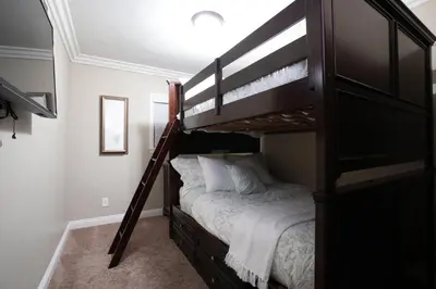 a bedroom with a bunk bed with a ladder to a bunk bed at Destination #08 in Anaheim