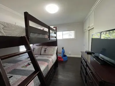 a bedroom with a bunk bed and a flat screen tv at Destination #12 in Anaheim