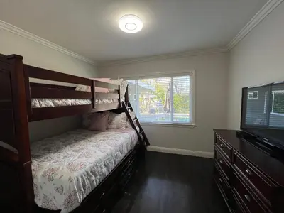 a bedroom with a bunk bed and a television at Destination #12 in Anaheim