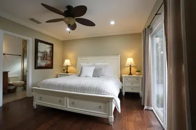a bedroom with a white bed and a ceiling fan at Destination #05 in Anaheim