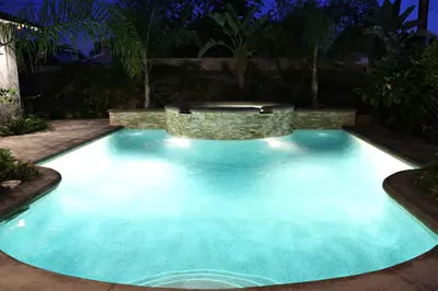 a large swimming pool at night with a spa at Destination #05 in Anaheim
