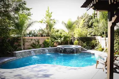 a swimming pool with a fountain in a yard at Destination #09 in Anaheim