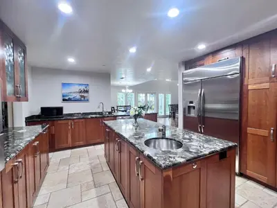 a large kitchen with a sink and a refrigerator at Destination #09 in Anaheim