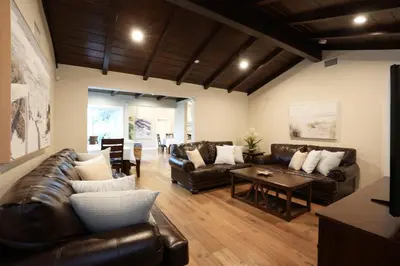 a living room with leather couches and a table at Destination #21 in Anaheim