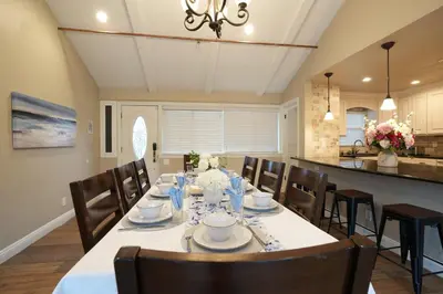 a dining room with a long table and chairs at Destination #21 in Anaheim