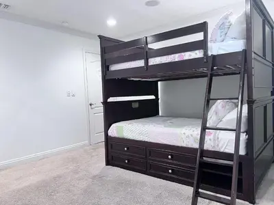a bedroom with two bunk beds with a ladder at Destination #16 in Anaheim