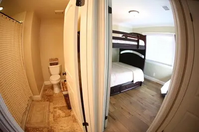 a small bedroom with a bunk bed and a toilet at Destination #26 in Anaheim