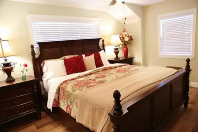 a bedroom with a large bed with red pillows at Destination #26 in Anaheim