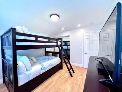 a bedroom with a bunk bed and a television at Destination #36 in Anaheim