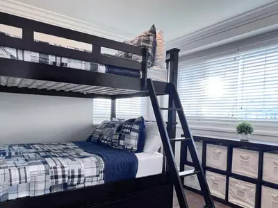 a bedroom with a bunk bed with a ladder at Destination #30 in Anaheim
