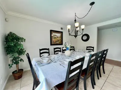 a dining room with a table with chairs and a chandelier at Destination #18 in Anaheim